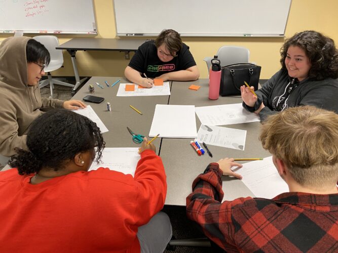 Digital Corps Fall 2022 new hires working hard on their collaboration skills during an onboarding activity.